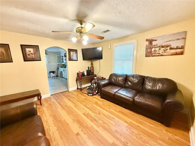 632 Eiseman St, Marrero, LA 70072 - living room with arched walkways, a textured ceiling, ceiling fan, and light wood-type flooring