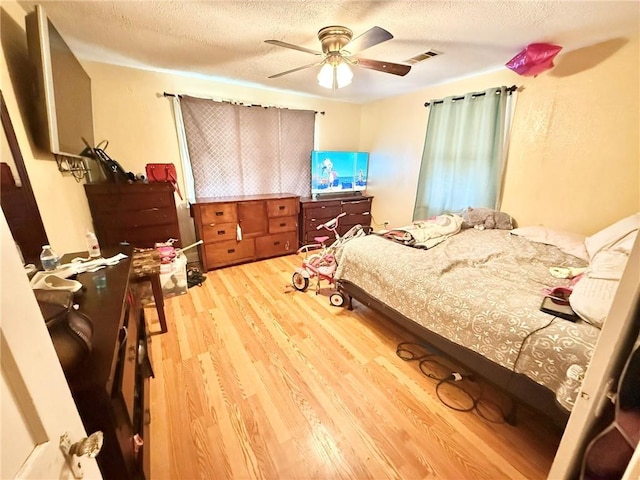 632 Eiseman St, Marrero, LA 70072 - bedroom with wood finished floors, a textured ceiling, and a ceiling fan