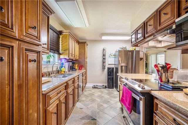 1500 Madewood Rd, La Place, LA 70068 - kitchen with appliances with stainless steel finishes, brown cabinetry, and light stone counters