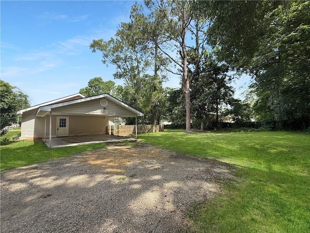200 N Steele Ave, Picayune, MS 39466 - view of side of home featuring driveway and a carport