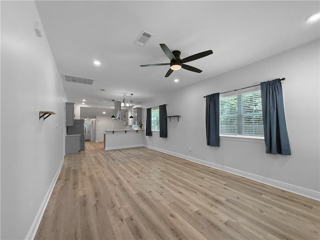 200 N Steele Ave, Picayune, MS 39466 - unfurnished living room with light wood-style floors, healthy amount of natural light, recessed lighting, and a ceiling fan