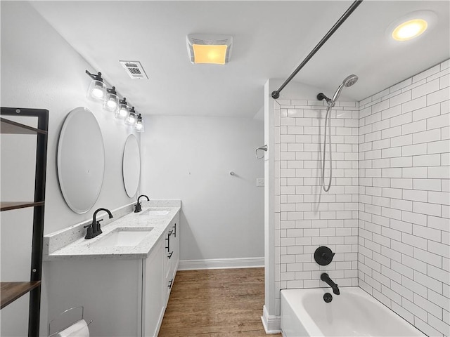 200 N Steele Ave, Picayune, MS 39466 - bathroom with double vanity, shower / washtub combination, and wood finished floors