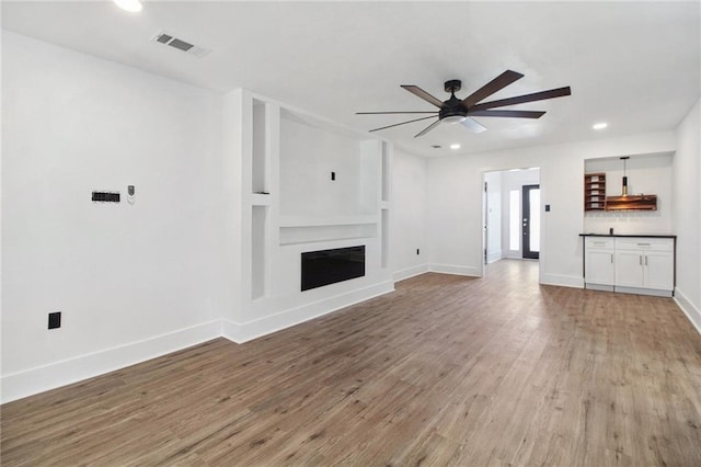 57 Driftwood Blvd, Kenner, LA 70065 - unfurnished living room with ceiling fan, light wood-style floors, recessed lighting, and a fireplace