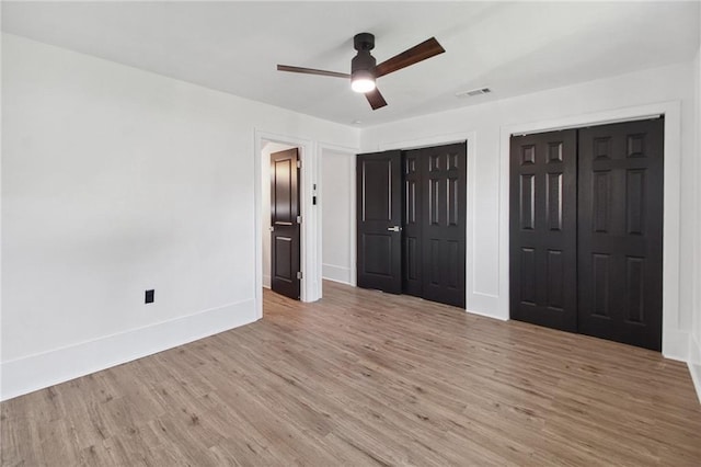 57 Driftwood Blvd, Kenner, LA 70065 - unfurnished bedroom with multiple closets, light wood finished floors, and ceiling fan