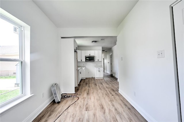 9126 Dixon St, New Orleans, LA 70118 - unfurnished living room with light wood-style flooring and baseboards