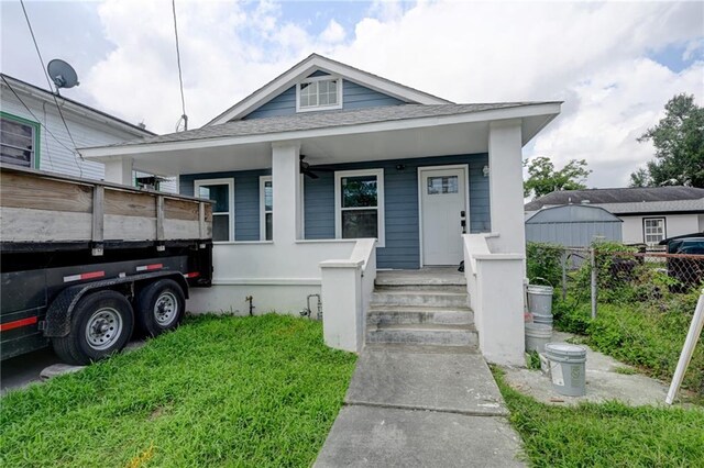 9126 Dixon St, New Orleans, LA 70118 - view of front facade featuring a porch and roof with shingles
