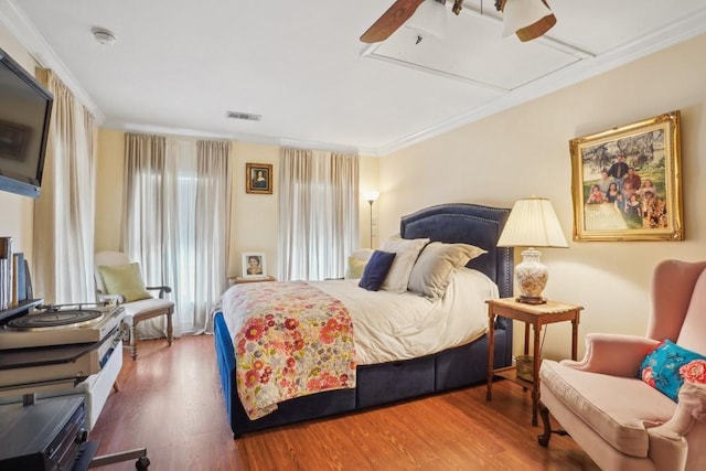 4320 Academy Dr, Metairie, LA 70003 - bedroom featuring ornamental molding, wood finished floors, attic access, and a ceiling fan
