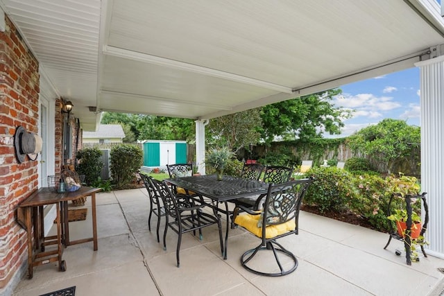 4320 Academy Dr, Metairie, LA 70003 - fenced backyard with outdoor dining space, a storage shed, and a patio area
