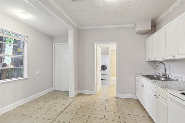 81214 Eliza St, New Orleans, LA 70114 - kitchen with white cabinets, ornamental molding, washer / clothes dryer, light tile patterned flooring, and light stone counters