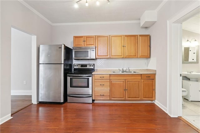 81214 Eliza St, New Orleans, LA 70114 - kitchen with appliances with stainless steel finishes, ornamental molding, dark wood-style flooring, light countertops, and backsplash