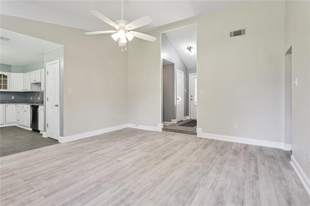 128 Hollow Rock Ct, Slidell, LA 70461 - unfurnished living room featuring ceiling fan, vaulted ceiling, and light wood-type flooring
