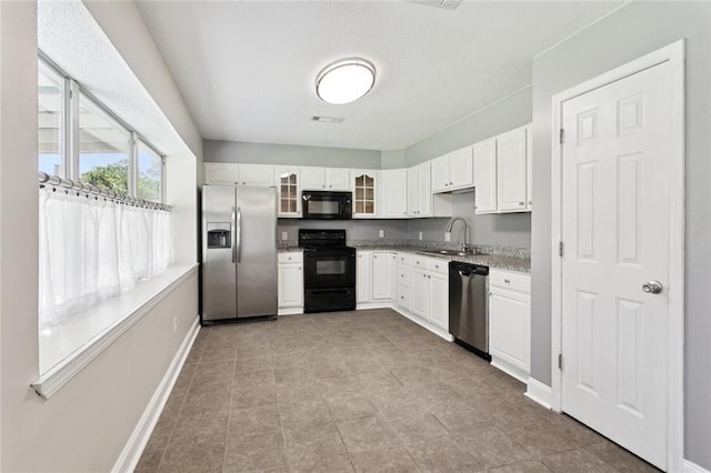 128 Hollow Rock Ct, Slidell, LA 70461 - kitchen featuring black appliances, glass insert cabinets, and white cabinetry