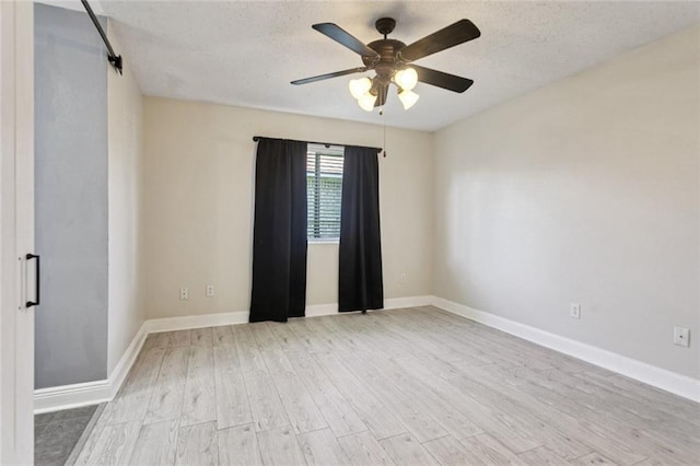 128 Hollow Rock Ct, Slidell, LA 70461 - unfurnished room with wood finished floors, ceiling fan, and a textured ceiling