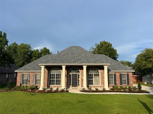 319 Red Maple Dr, Mandeville, LA 70448 - view of front of house featuring a front lawn, brick siding, and a shingled roof