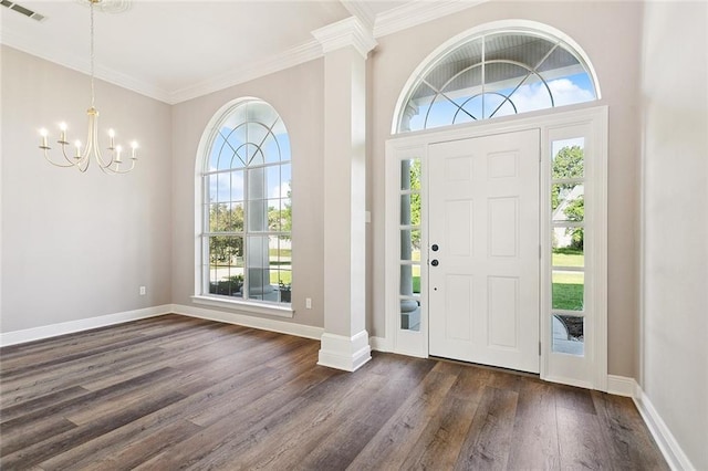 319 Red Maple Dr, Mandeville, LA 70448 - foyer entrance with a chandelier, crown molding, and dark wood finished floors
