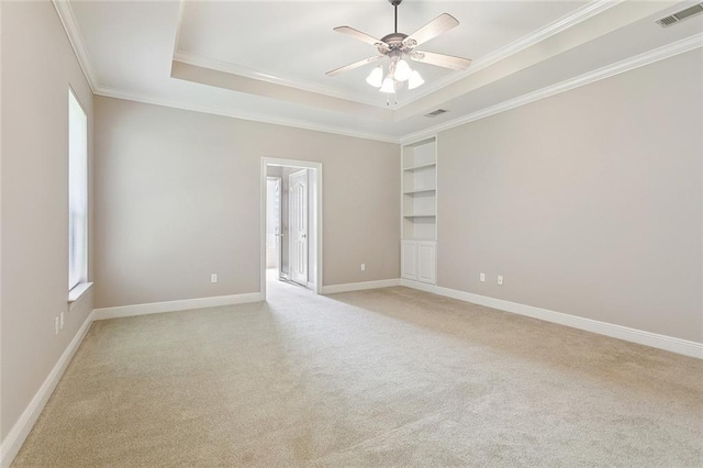 319 Red Maple Dr, Mandeville, LA 70448 - empty room featuring healthy amount of natural light, light colored carpet, a ceiling fan, ornamental molding, and a tray ceiling