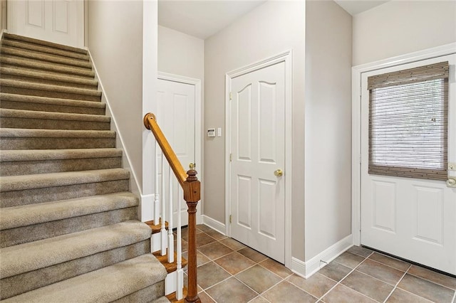 319 Red Maple Dr, Mandeville, LA 70448 - tiled foyer entrance featuring stairway and baseboards