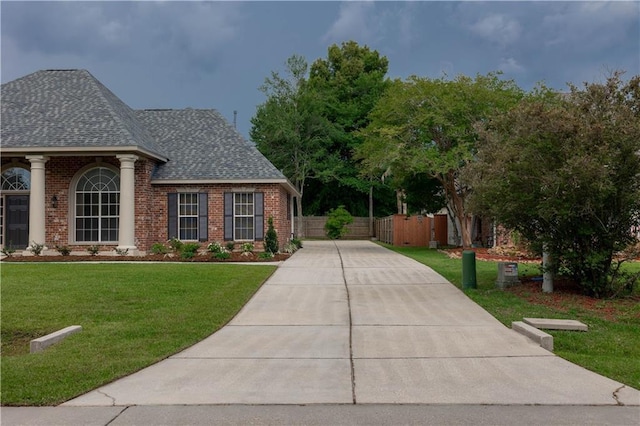 319 Red Maple Dr, Mandeville, LA 70448 - view of front of home with brick siding, roof with shingles, and concrete driveway