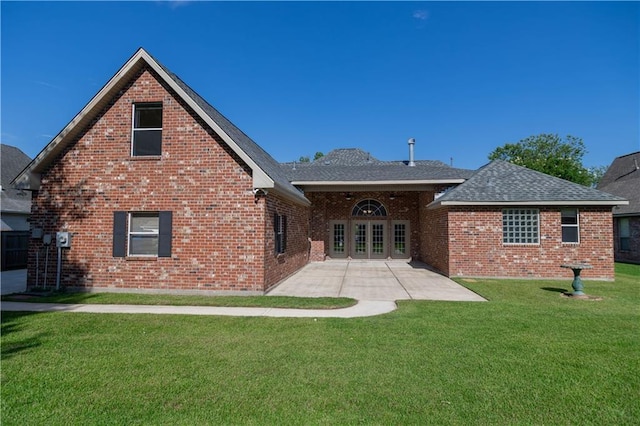 319 Red Maple Dr, Mandeville, LA 70448 - back of house with a yard, brick siding, a shingled roof, a patio area, and french doors