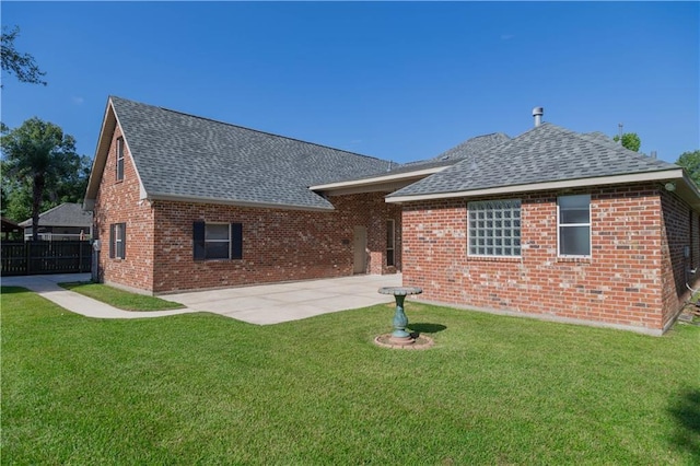 319 Red Maple Dr, Mandeville, LA 70448 - rear view of property featuring a shingled roof, a patio, and brick siding