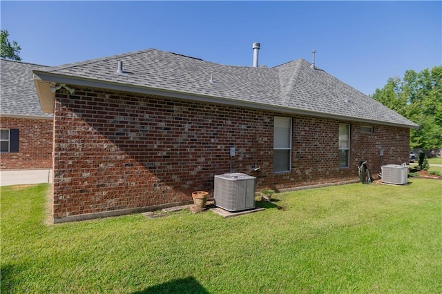 319 Red Maple Dr, Mandeville, LA 70448 - back of house featuring brick siding, a yard, and a shingled roof