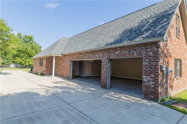 319 Red Maple Dr, Mandeville, LA 70448 - view of property exterior with driveway, brick siding, and roof with shingles