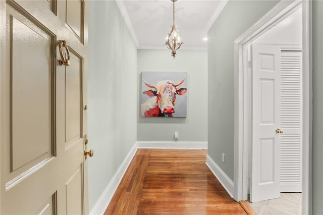 5421 St Charles Ave Unit 2D, New Orleans, LA 70115 - corridor with crown molding, light wood-style flooring, and a chandelier