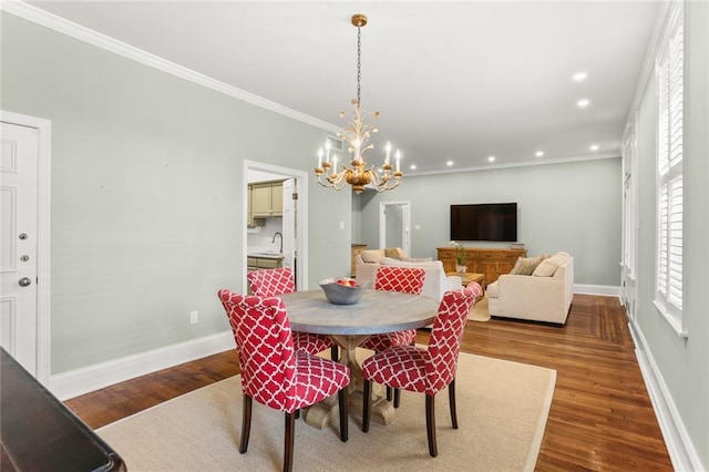 5421 St Charles Ave Unit 2D, New Orleans, LA 70115 - dining area featuring a chandelier, ornamental molding, dark wood finished floors, and recessed lighting