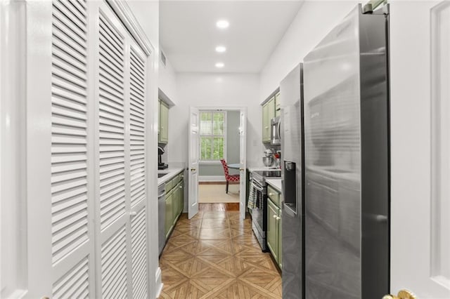 5421 St Charles Ave Unit 2D, New Orleans, LA 70115 - kitchen with stainless steel appliances, green cabinets, recessed lighting, and light countertops