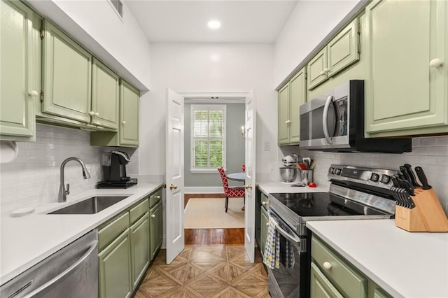 5421 St Charles Ave Unit 2D, New Orleans, LA 70115 - kitchen featuring green cabinets, appliances with stainless steel finishes, light countertops, tasteful backsplash, and recessed lighting
