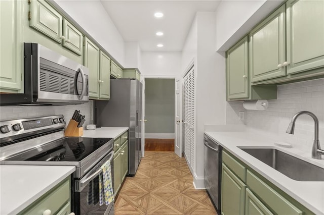 5421 St Charles Ave Unit 2D, New Orleans, LA 70115 - kitchen with green cabinets, appliances with stainless steel finishes, light countertops, and recessed lighting
