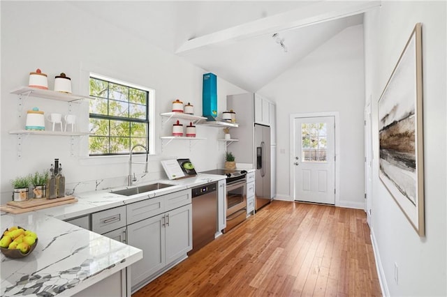 1431 Port St, New Orleans, LA 70117 - kitchen featuring open shelves, appliances with stainless steel finishes, light stone counters, light wood-type flooring, and lofted ceiling