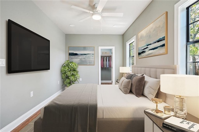 1431 Port St, New Orleans, LA 70117 - bedroom featuring multiple windows, wood finished floors, and a ceiling fan
