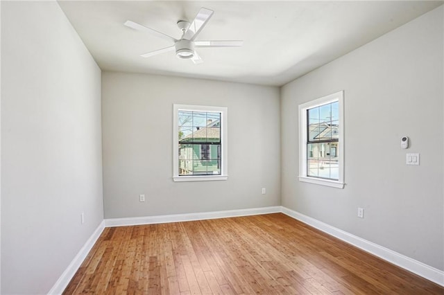1431 Port St, New Orleans, LA 70117 - spare room featuring healthy amount of natural light, wood-type flooring, and a ceiling fan