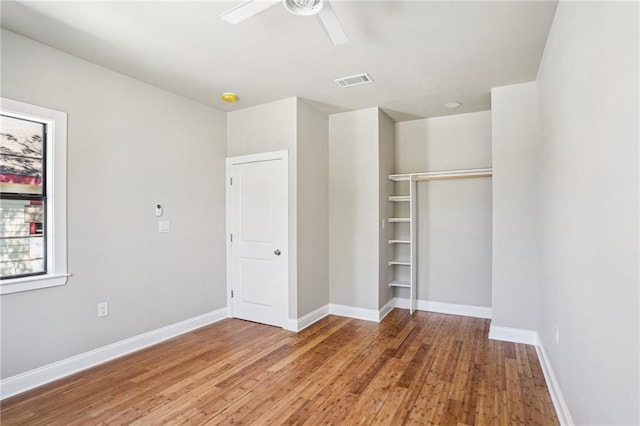 1431 Port St, New Orleans, LA 70117 - unfurnished bedroom with wood finished floors, a ceiling fan, and a closet