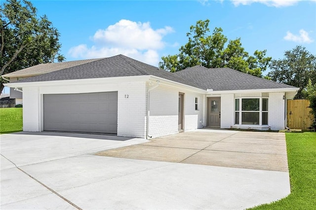 12 Fairlane Dr, Metairie, LA 70003 - ranch-style house featuring an attached garage, concrete driveway, brick siding, and roof with shingles