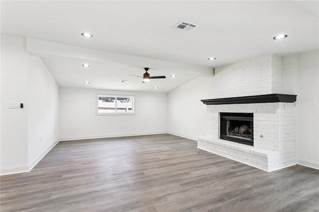 12 Fairlane Dr, Metairie, LA 70003 - unfurnished living room featuring ceiling fan, wood finished floors, a brick fireplace, recessed lighting, and lofted ceiling