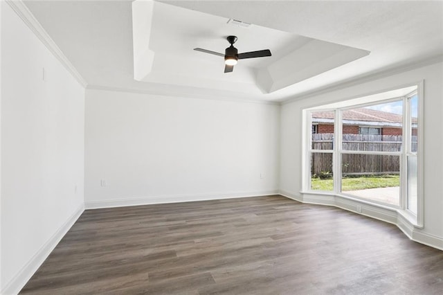 12 Fairlane Dr, Metairie, LA 70003 - unfurnished room with a raised ceiling, healthy amount of natural light, ceiling fan, dark wood finished floors, and ornamental molding