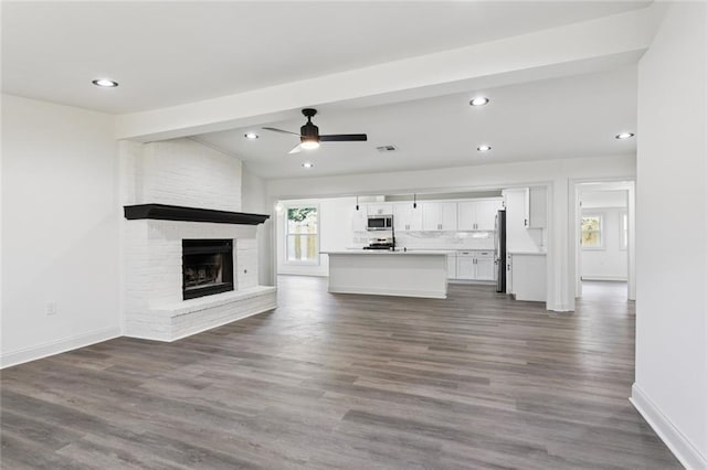 12 Fairlane Dr, Metairie, LA 70003 - unfurnished living room with recessed lighting, dark wood-type flooring, ceiling fan, and a brick fireplace