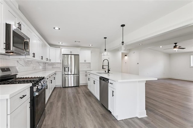 12 Fairlane Dr, Metairie, LA 70003 - kitchen with stainless steel appliances, light wood-style flooring, decorative backsplash, recessed lighting, and light countertops
