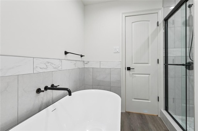 12 Fairlane Dr, Metairie, LA 70003 - full bath featuring wood finished floors, a soaking tub, and a shower stall