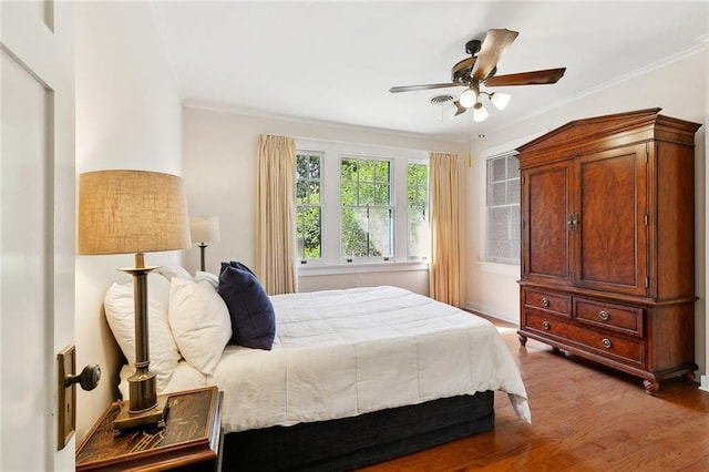 1338 Fern St, New Orleans, LA 70118 - bedroom featuring wood finished floors, a ceiling fan, and crown molding