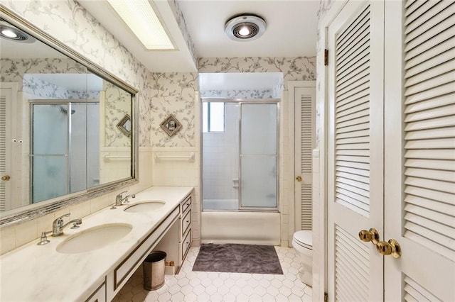 1338 Fern St, New Orleans, LA 70118 - bathroom featuring a closet, wallpapered walls, double vanity, combined bath / shower with glass door, and tile patterned floors