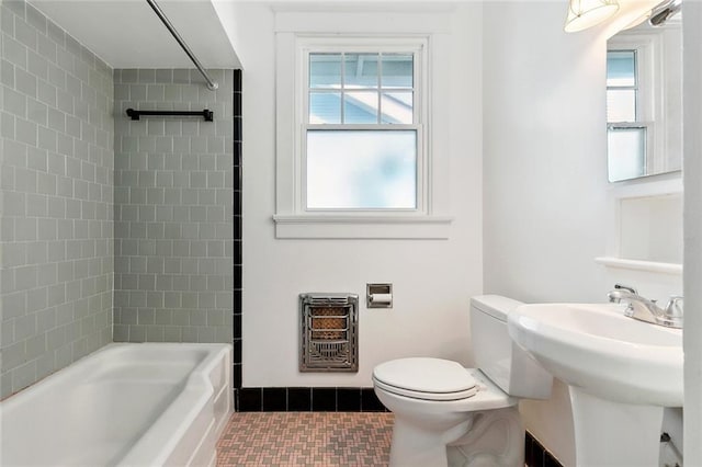 1338 Fern St, New Orleans, LA 70118 - bathroom featuring heating unit, tile patterned floors, tub / shower combination, and healthy amount of natural light