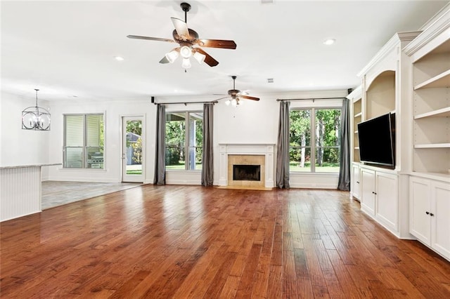 217 Sap Berry Dr, Madisonville, LA 70447 - unfurnished living room with a fireplace, hardwood / wood-style flooring, ceiling fan, a chandelier, and recessed lighting