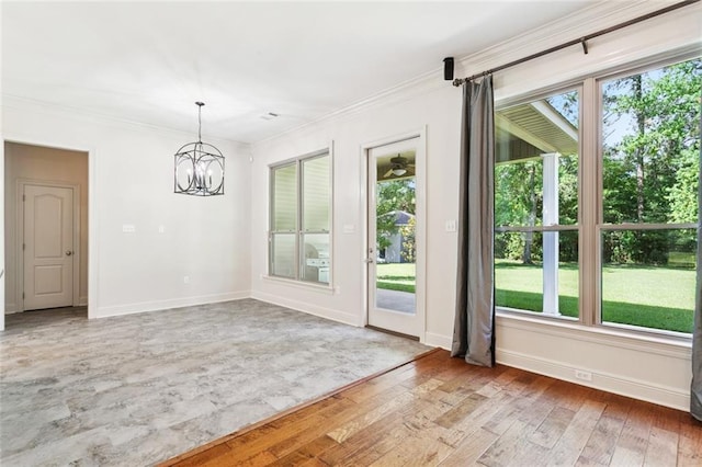 217 Sap Berry Dr, Madisonville, LA 70447 - unfurnished dining area with a chandelier, light wood-style flooring, and crown molding