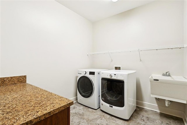 217 Sap Berry Dr, Madisonville, LA 70447 - laundry area featuring washing machine and clothes dryer and baseboards