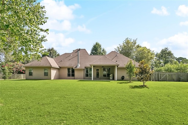 217 Sap Berry Dr, Madisonville, LA 70447 - back of property featuring a ceiling fan, a fenced backyard, and roof with shingles