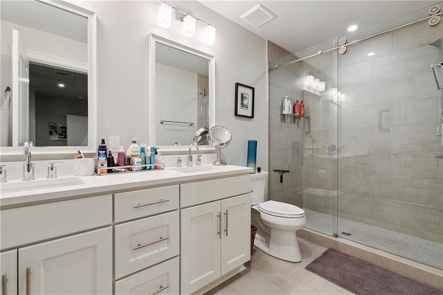 731 St Charles Ave Unit 310, New Orleans, LA 70130 - bathroom featuring double vanity, a shower stall, and tile patterned floors