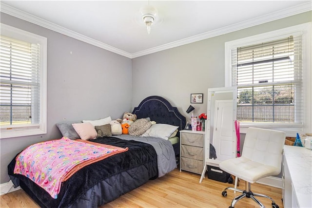 82 Packenham Ave, Chalmette, LA 70043 - bedroom with multiple windows, light wood finished floors, and crown molding